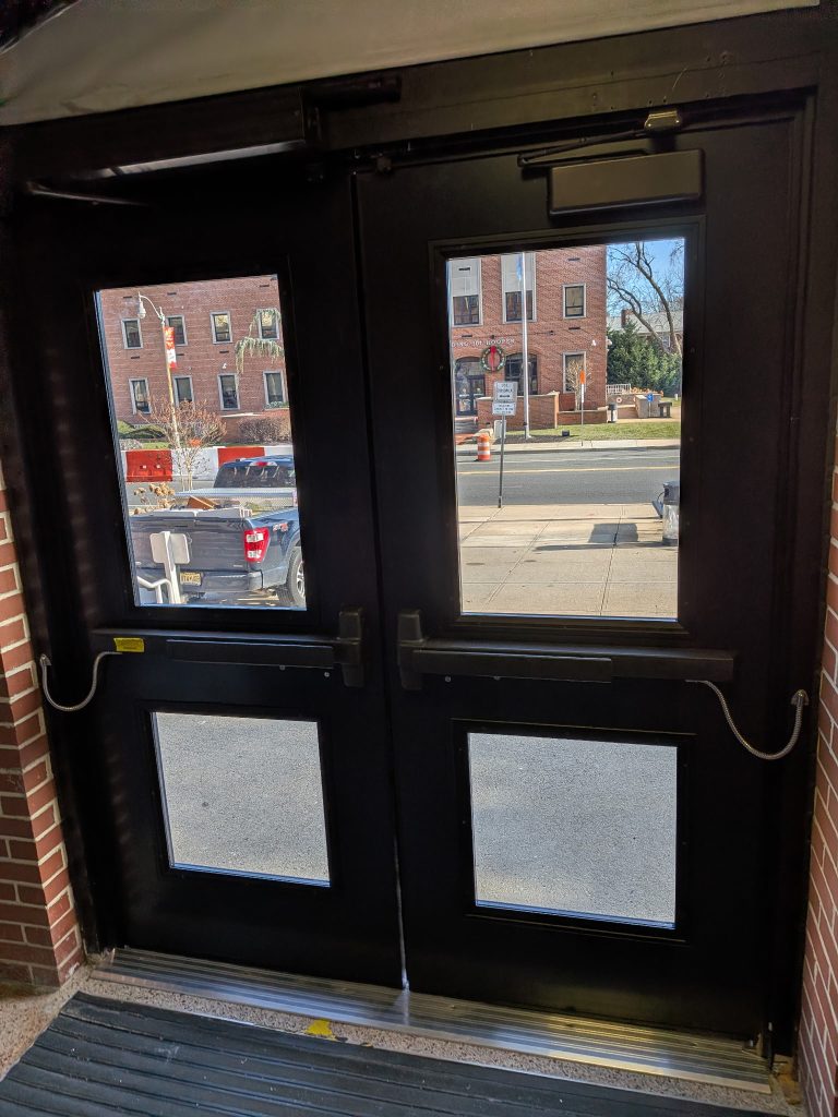 Black commercial double entry doors with glass lites and closers